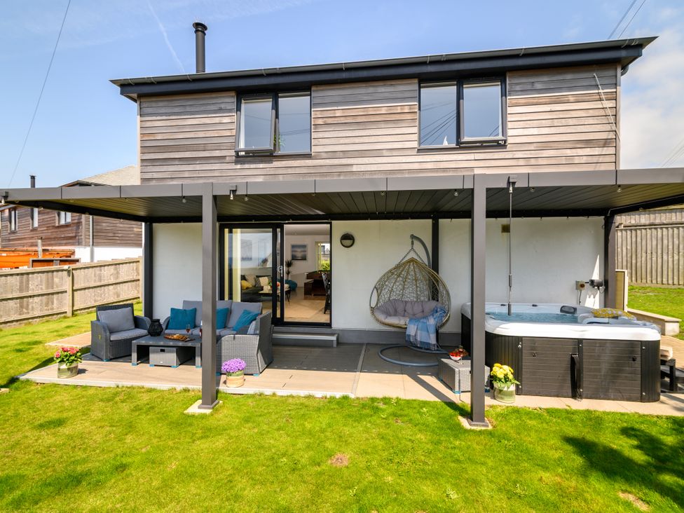 An outdoor area with seating and a whirlpool spa at Sandy Cove in Praa Sands