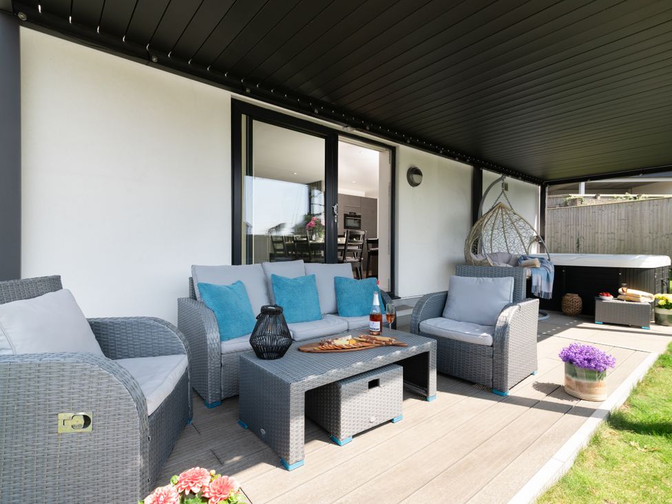 An outdoor seating area with furniture at Sandy Cove in Praa Sands