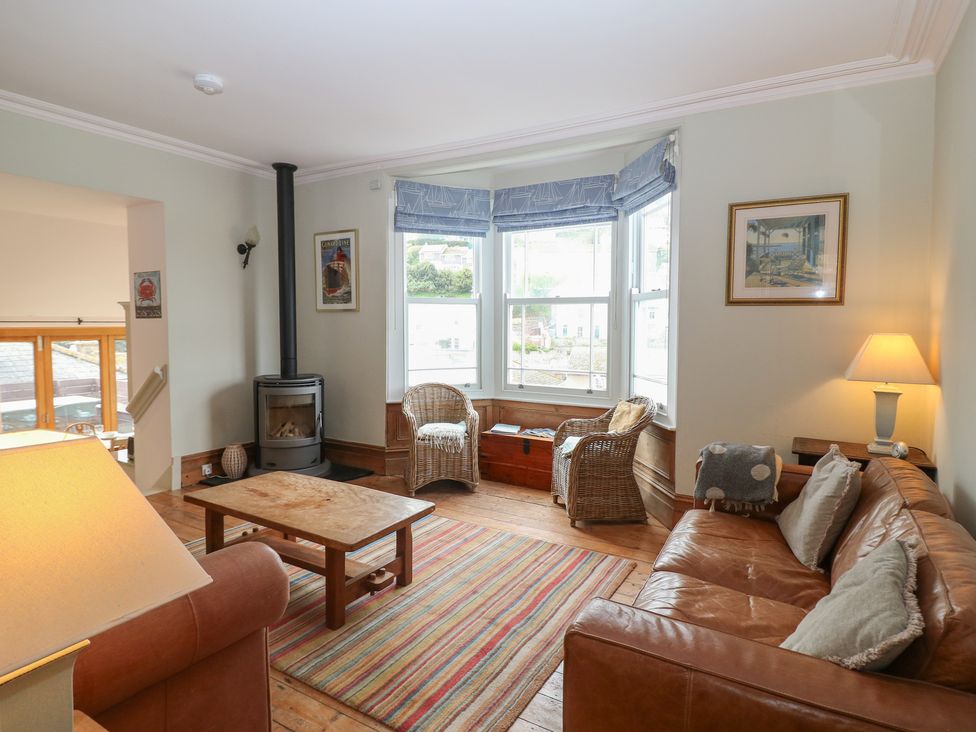 A living room with a sofa and armchairs at Kipper Lodge in Dartmouth