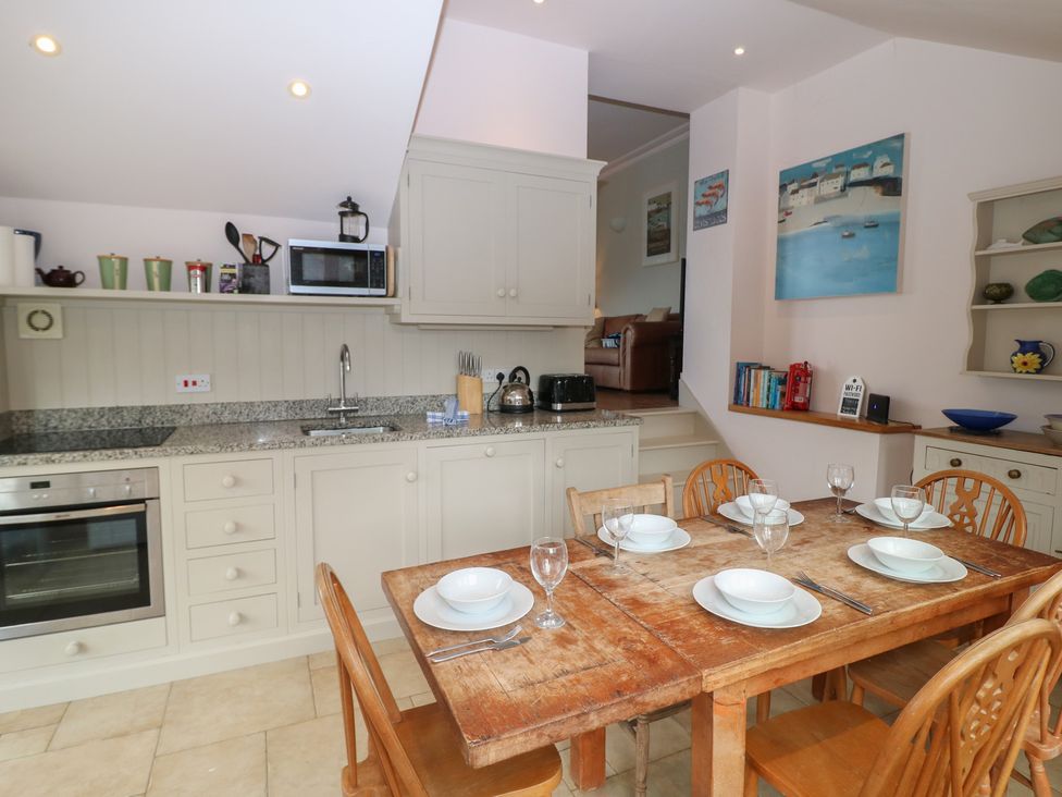 A kitchen with a dining table set at Kipper Lodge in Dartmouth