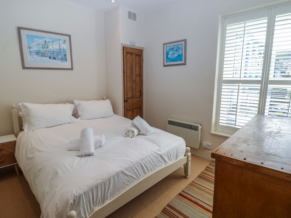 A bedroom with a bed and towels on the bed at Kipper Lodge in Dartmouth