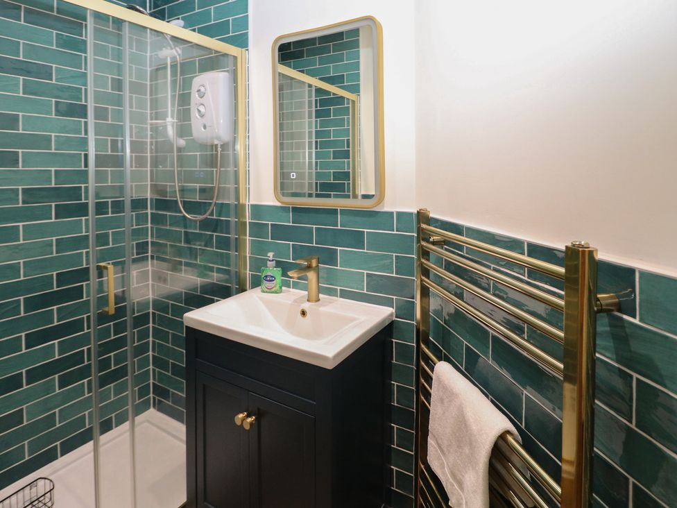 A bathroom with a shower and sink at Kipper Lodge Dartmouth