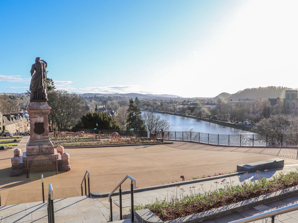 A statue overlooking a river at Porter's Lodge in Inverness