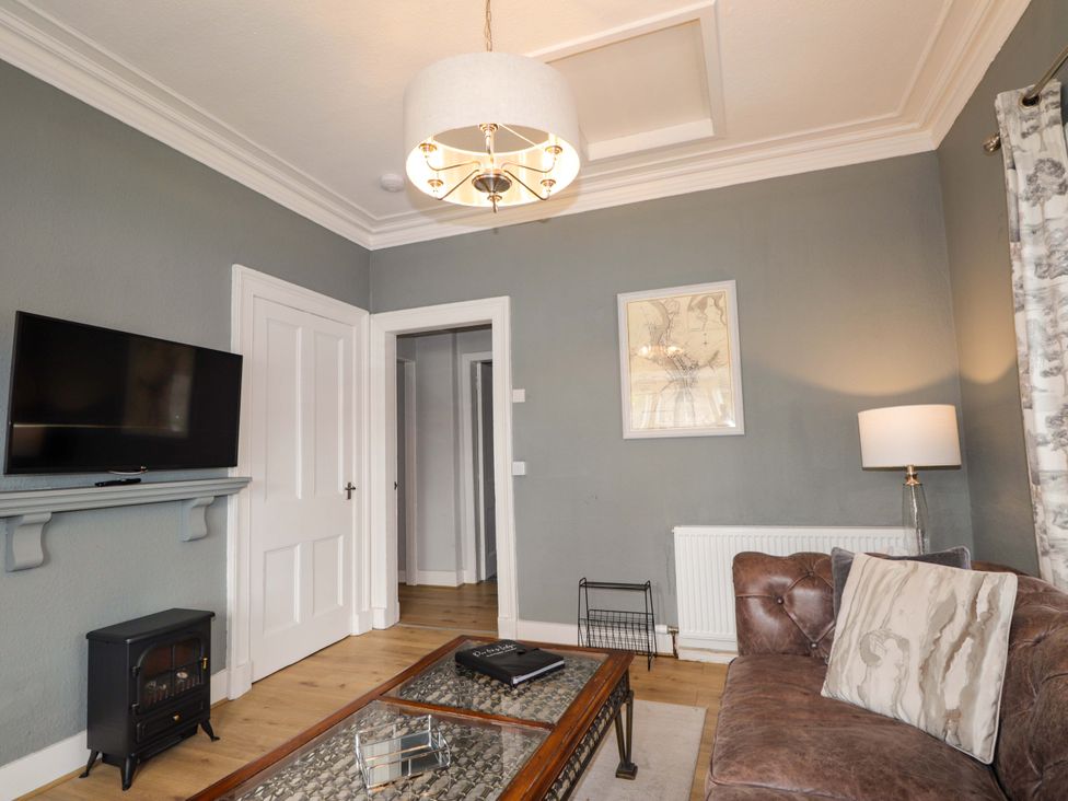 A living room with a television and sofa at Porter's Lodge in Inverness