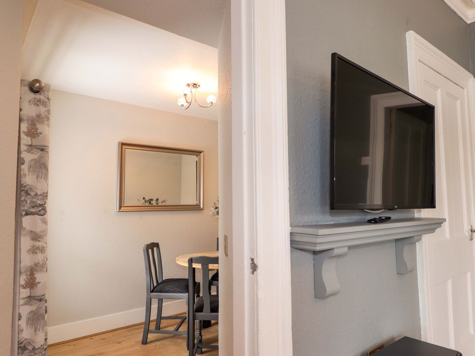 A dining room with a table and chairs at Porter's Lodge Inverness