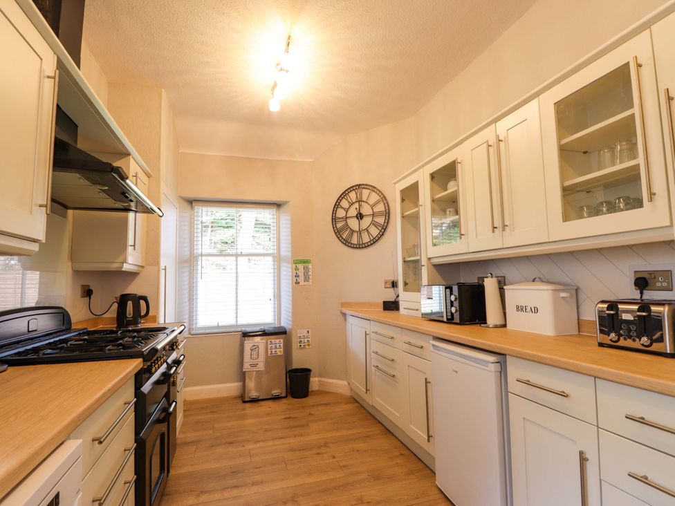 A kitchen with appliances and cabinets at Porter's Lodge in Inverness