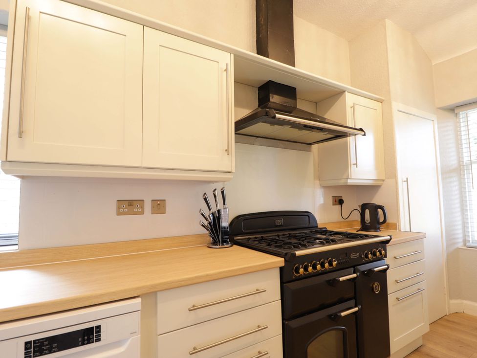 A kitchen with cabinets and appliances at Porter's Lodge in Inverness