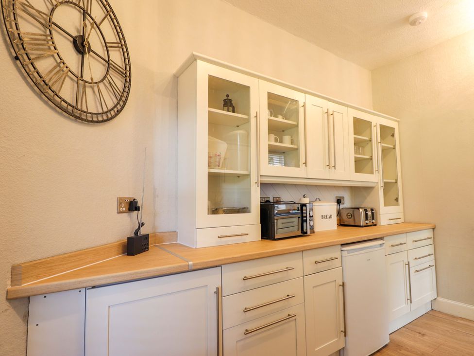 A kitchen with cabinets and appliances at Porter's Lodge in Inverness