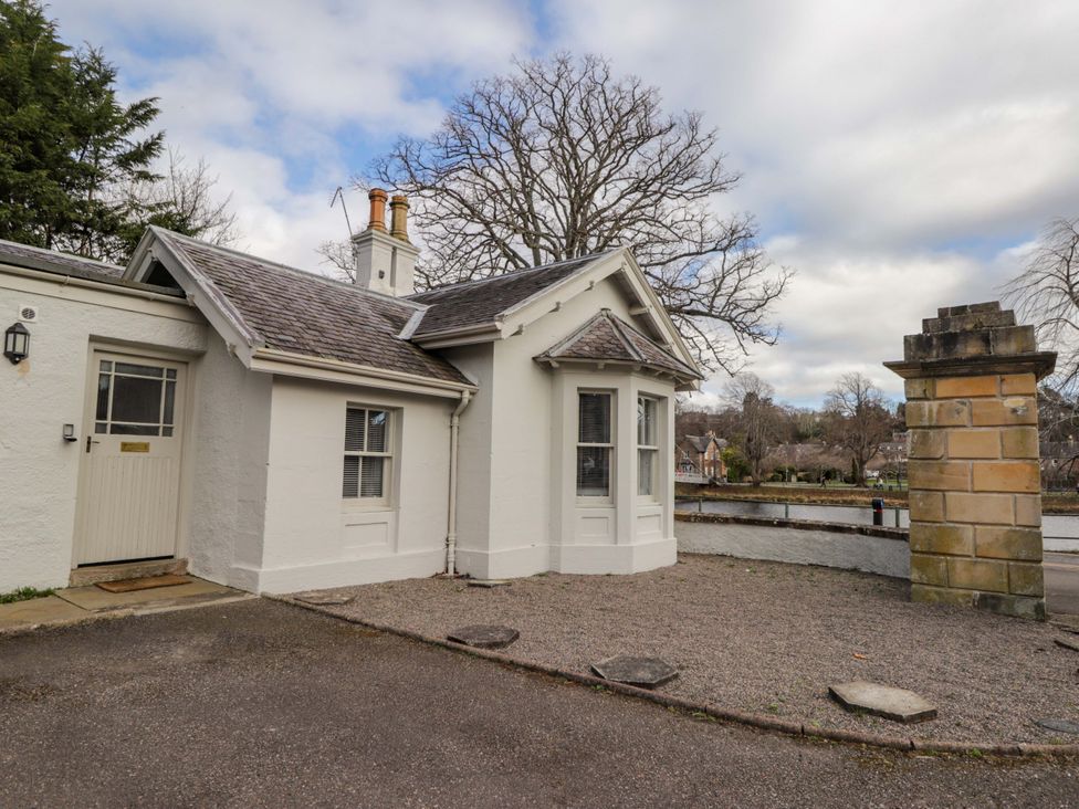 An exterior view of a house with a pathway at Porter's Lodge in Inverness