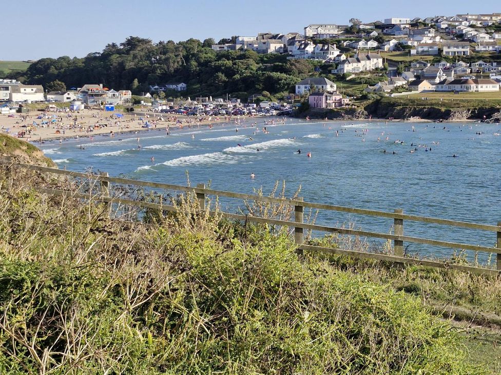 A beach scene with people swimming at Kirland St Kew Highway