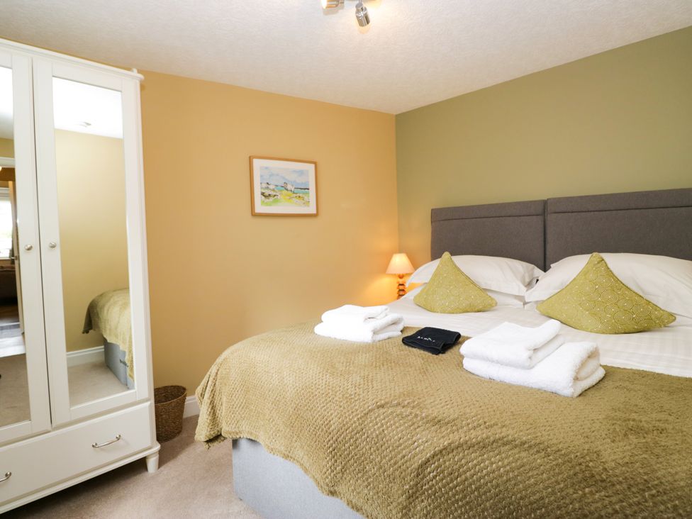 A bedroom with a bed and wardrobe at Jenny's in Hawkshead