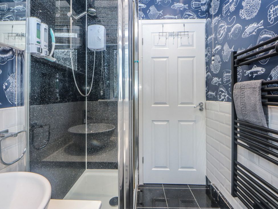 A bathroom with a shower and toilet at Ty Glan Morfa in Morfa Bychan