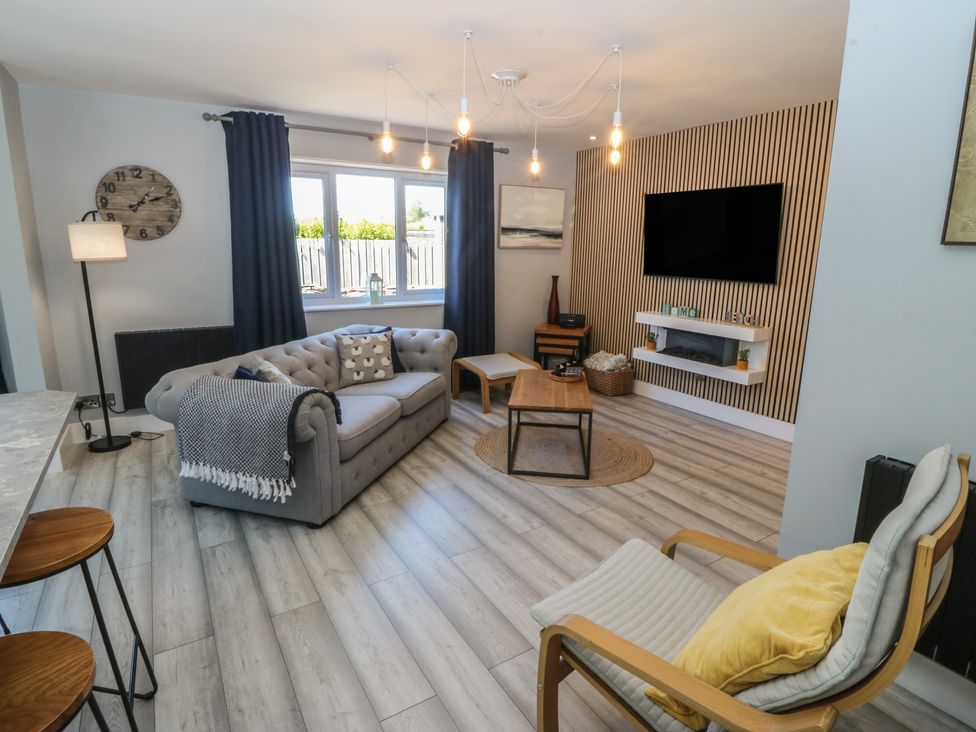 A living room with a sofa and coffee table at Ty Glan Morfa in Morfa Bychan