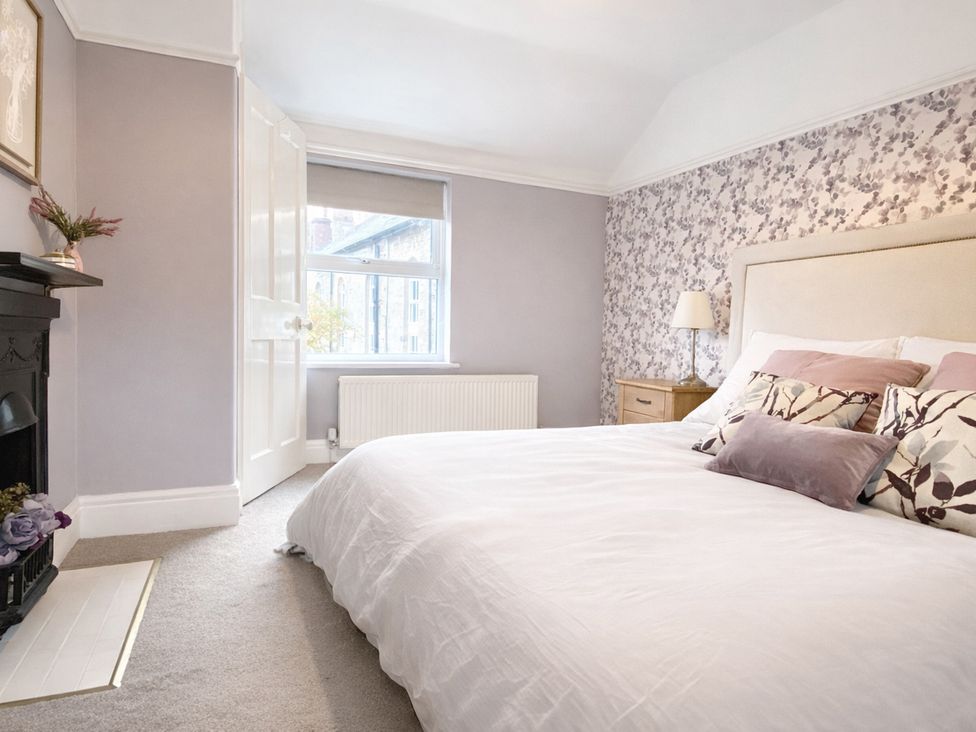 A bedroom with a bed and window at Waterfall Cottage in Dyserth