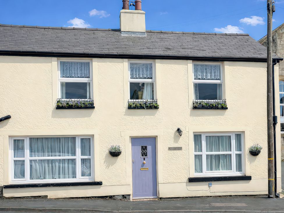 A house facade with windows and a door at Waterfall Cottage in Dyserth