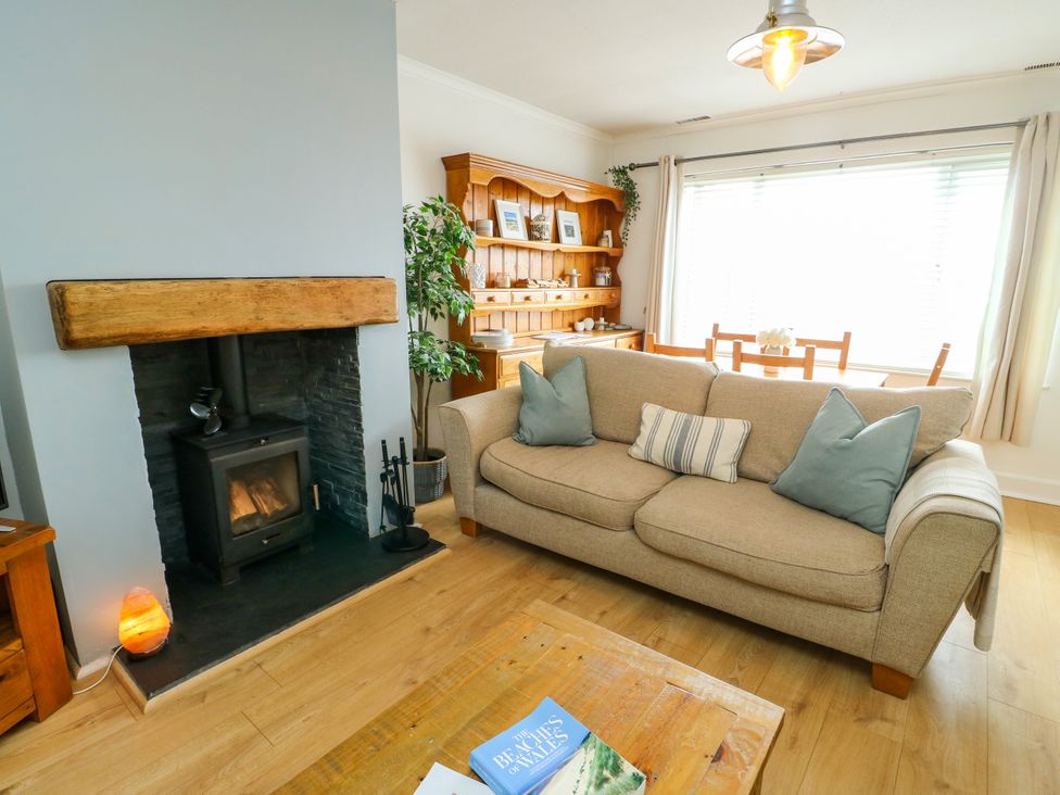 A living room with a fireplace and dining area at Valley Pines in Valley