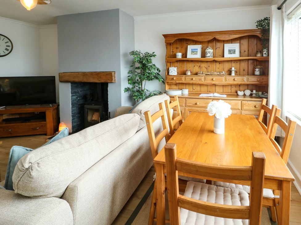 A living room with a sofa and dining area at Valley Pines in Valley