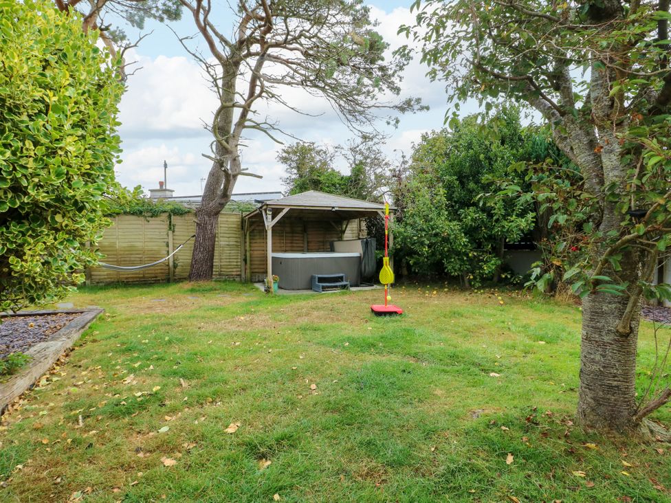 A garden with a playset and hot tub at Valley Pines in Valley