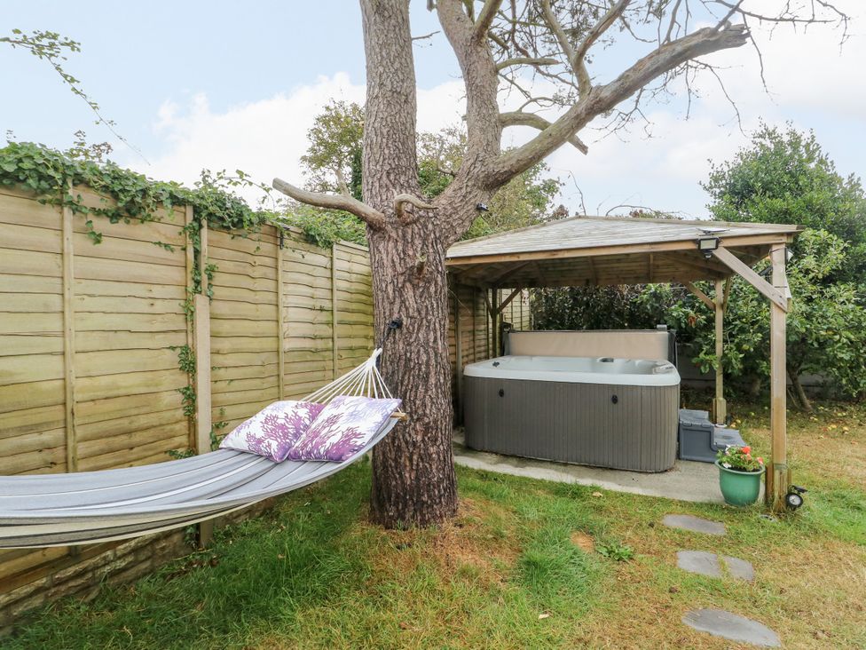 A garden with a hammock and hot tub at Valley Pines in Valley