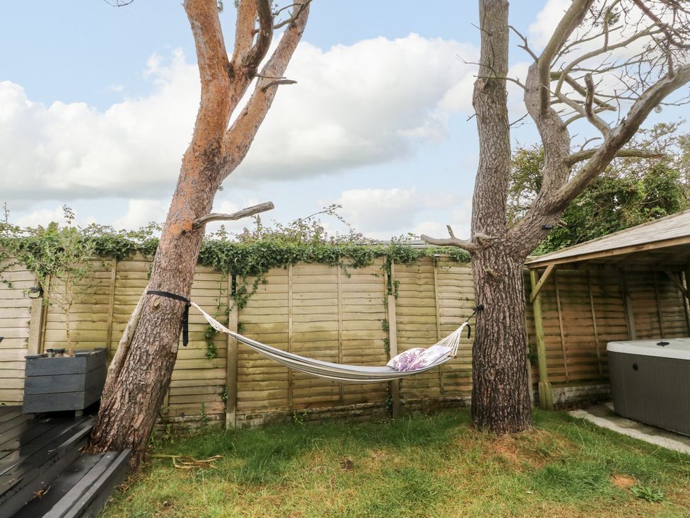 A garden with a hammock between two trees at Valley Pines in Valley