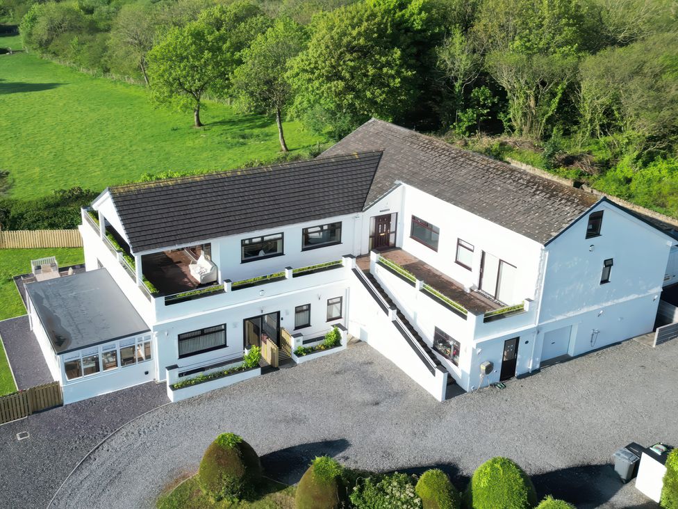 A house with balconies and a garden at Top Of The Lane Luxury Holiday Apartment in Benllech