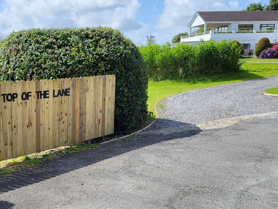 A sign at the entrance to Top Of The Lane Luxury Holiday Apartment in Benllech