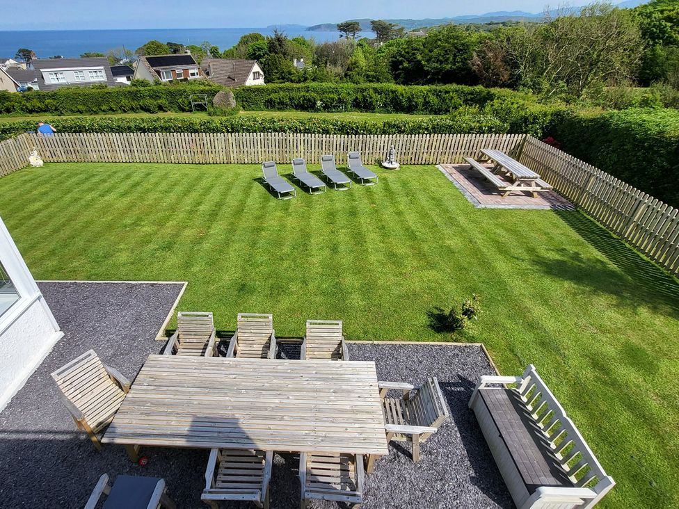A garden with table and chairs at Top Of The Lane Luxury Holiday Apartment in Benllech