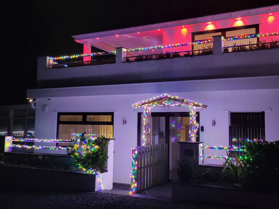 A house decorated with colorful lights at Top Of The Lane Luxury Holiday Apartment in Benllech