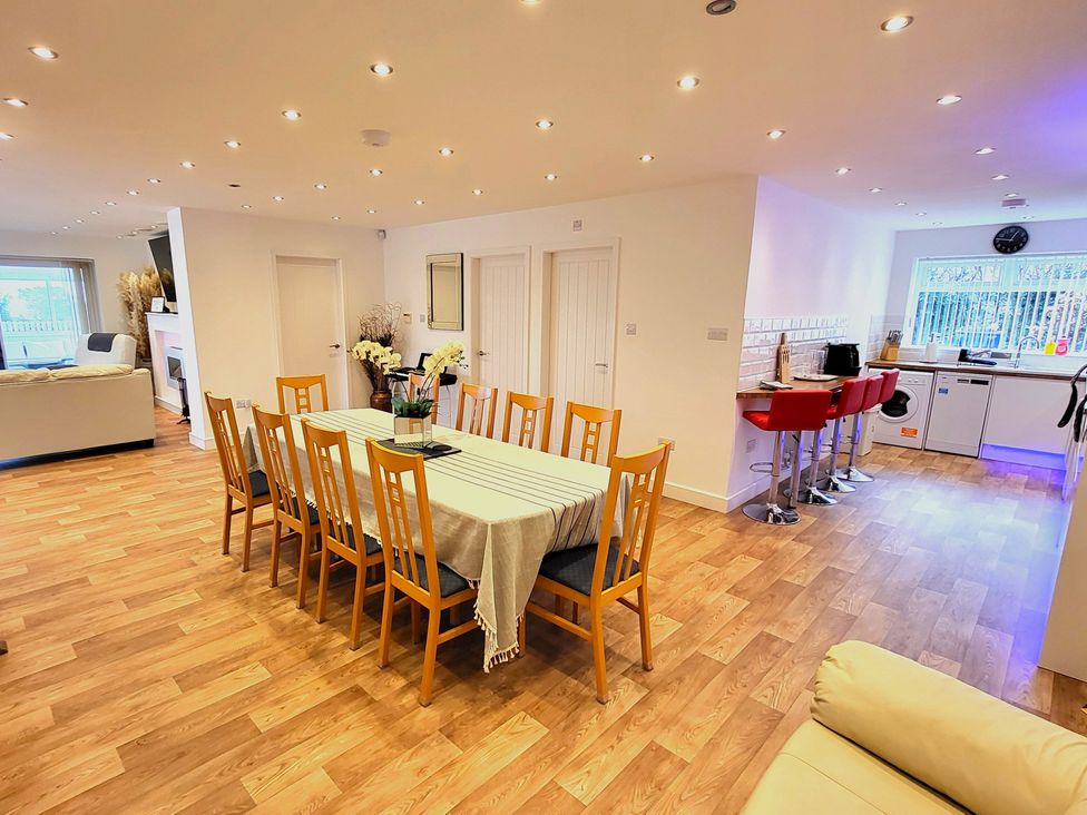 A dining room with a table and chairs at Top Of The Lane Luxury Holiday Apartment Benllech