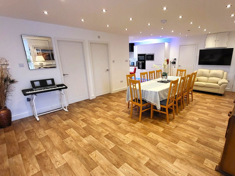 A dining room with a table and chairs at Top Of The Lane Luxury Holiday Apartment Benllech