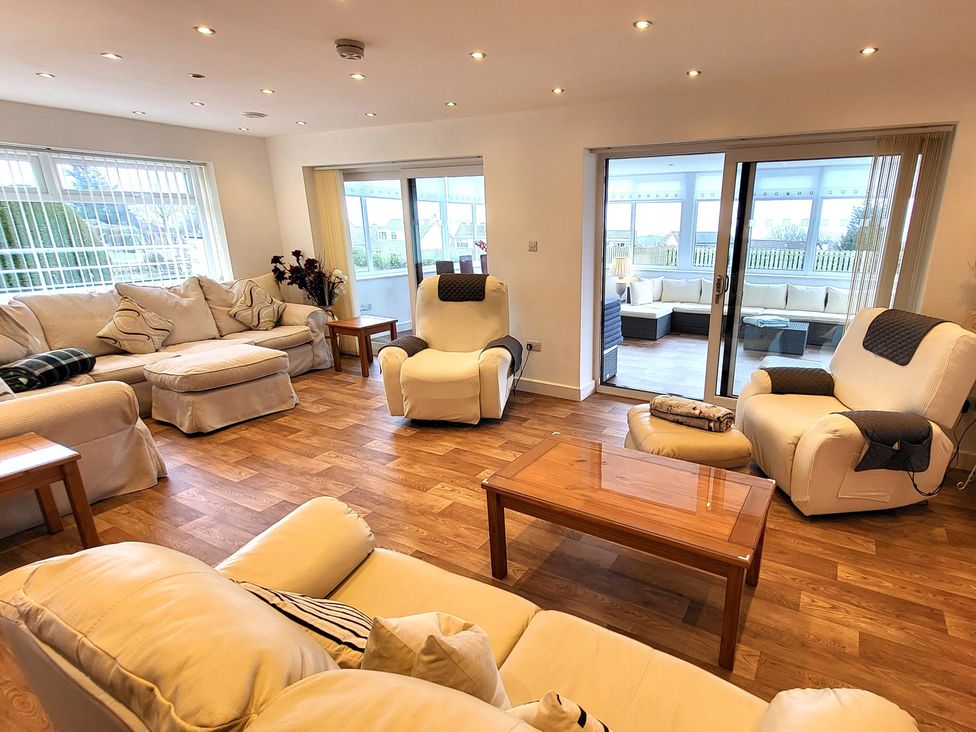 A living room with sofas and a coffee table at Top Of The Lane Luxury Holiday Apartment in Benllech