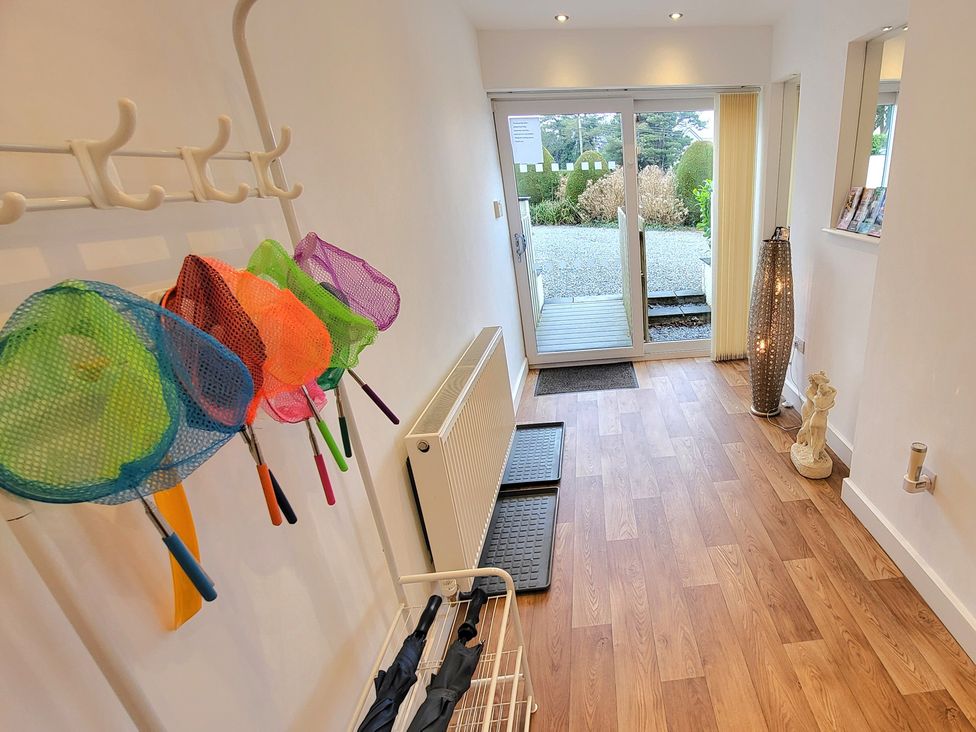 A hallway with colorful nets on a rack at Top Of The Lane Luxury Holiday Apartment Benllech