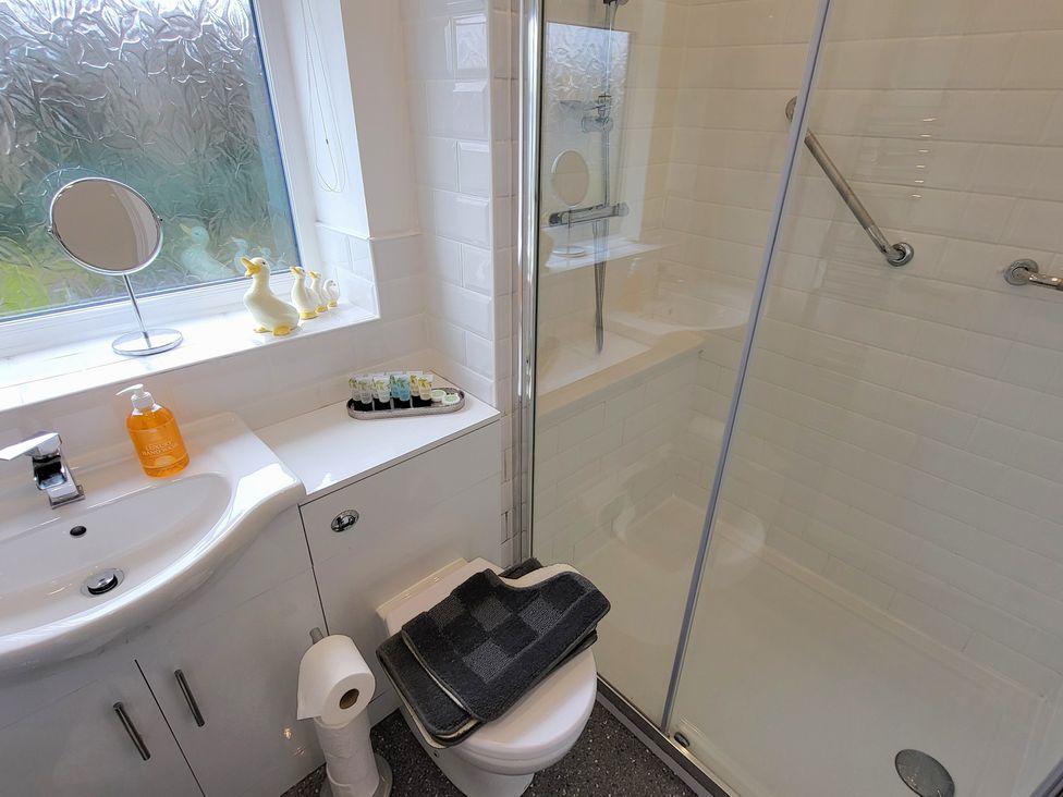 A bathroom with a shower and sink at Top Of The Lane Luxury Holiday Apartment in Benllech