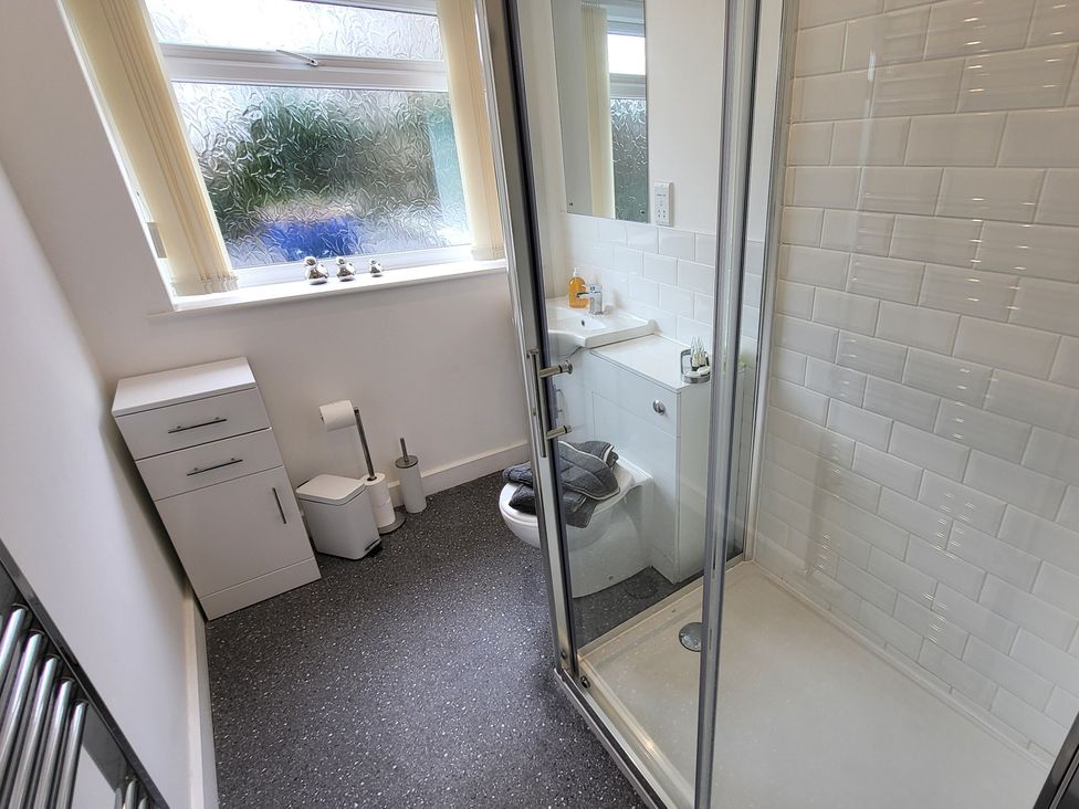 A bathroom with a shower and a sink at Top Of The Lane Luxury Holiday Apartment in Benllech