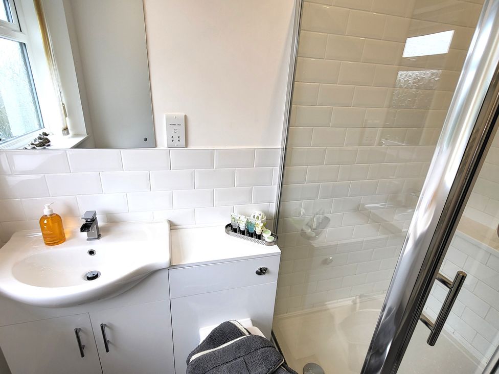 A bathroom with a sink and shower at Top Of The Lane Luxury Holiday Apartment in Benllech