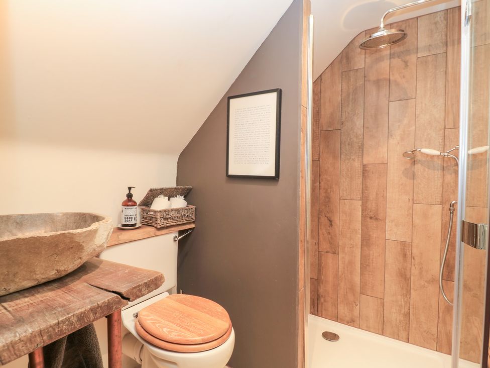 A bathroom with a shower and sink at Pudding Hill Barn Cottage in Bibury