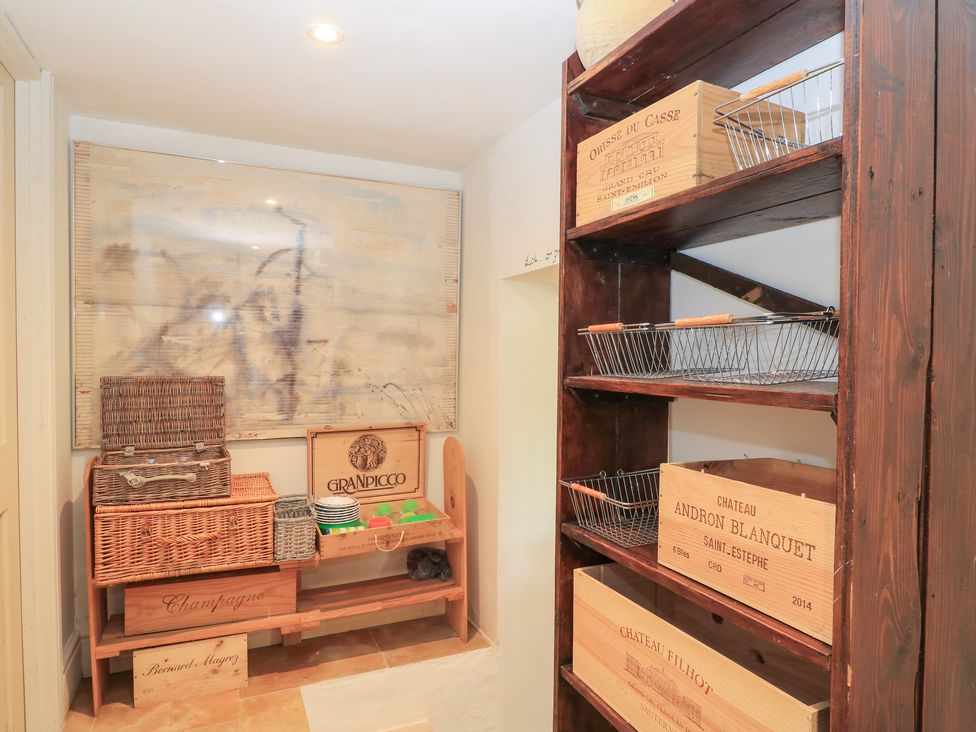 A storage room with shelves and baskets at Pudding Hill Barn Cottage Bibury
