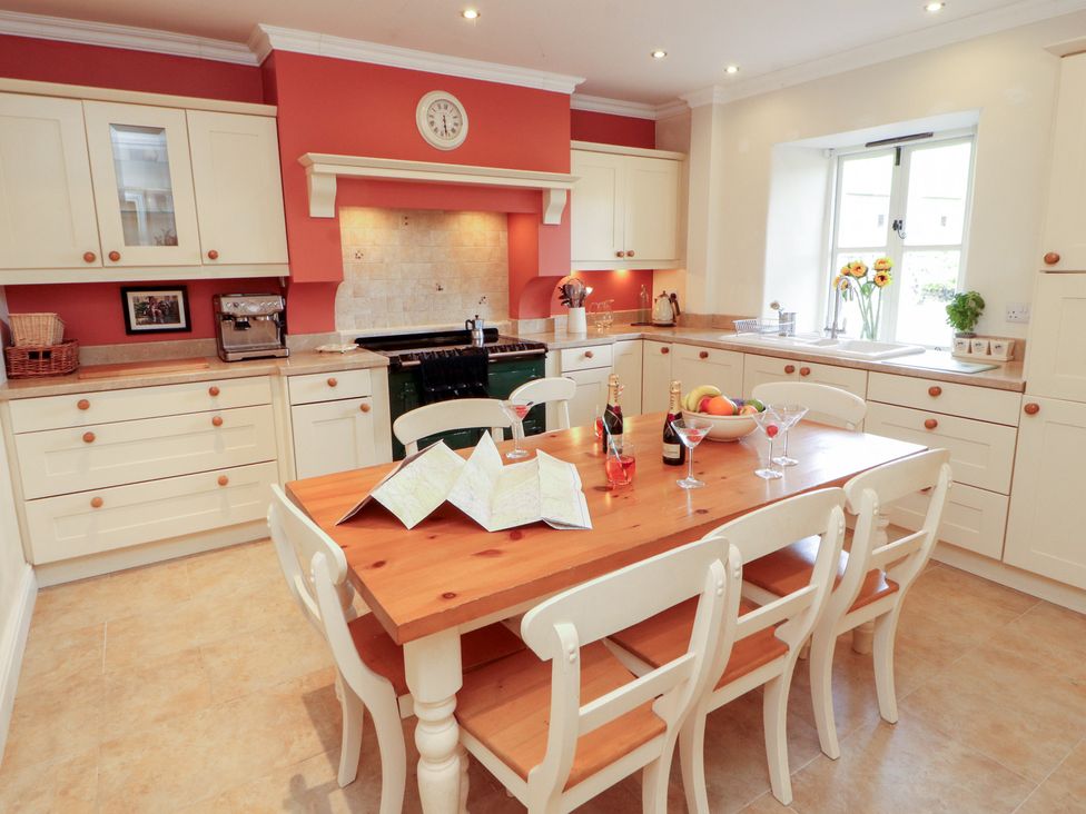A kitchen with a table and chairs at Garsdale Foot in Sedbergh