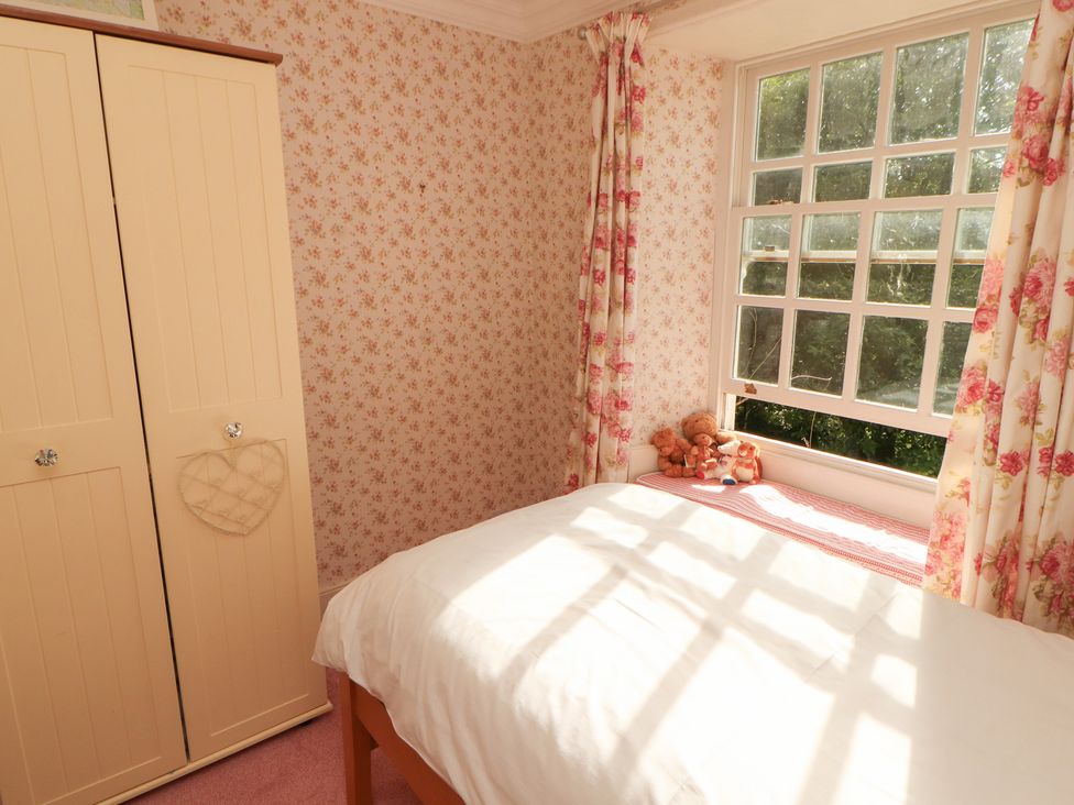 A bedroom with a bed and wardrobe at Garsdale Foot Sedbergh