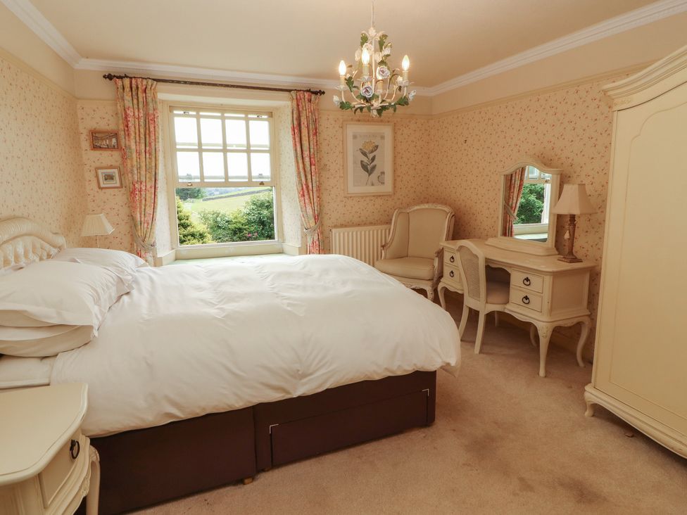 A bedroom with a bed and window at Garsdale Foot in Sedbergh