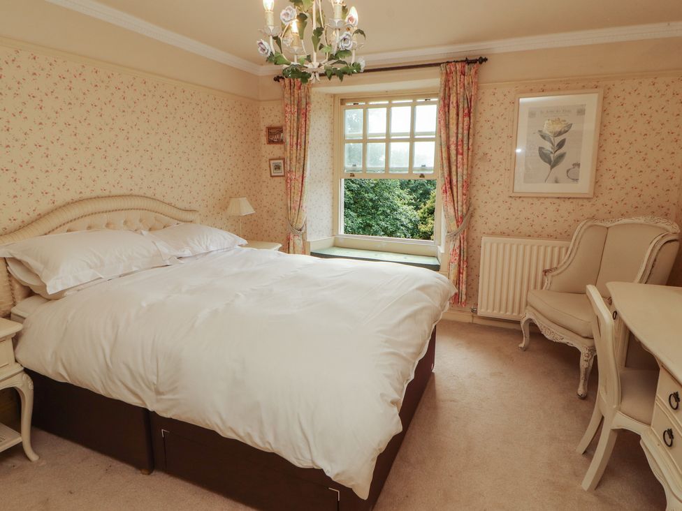 A bedroom with a bed and a window at Garsdale Foot in Sedbergh