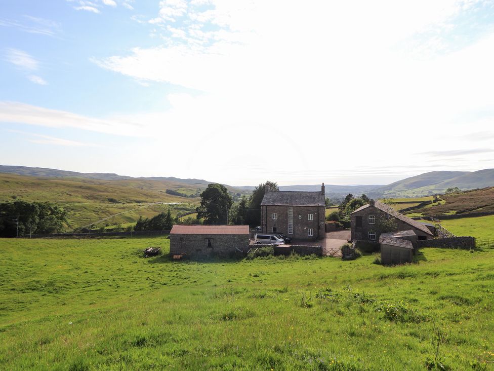 A house and barn in a field at Garsdale Foot in Sedbergh
