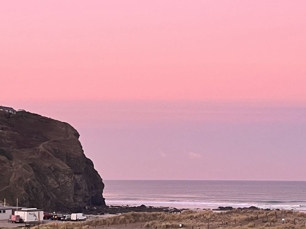 A coastal scene with a cliff and sea at Kippy Cottage in Truro
