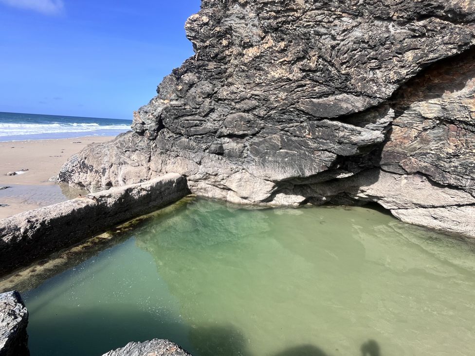 A rocky coastline with a pool of water at Kippy Cottage in Truro