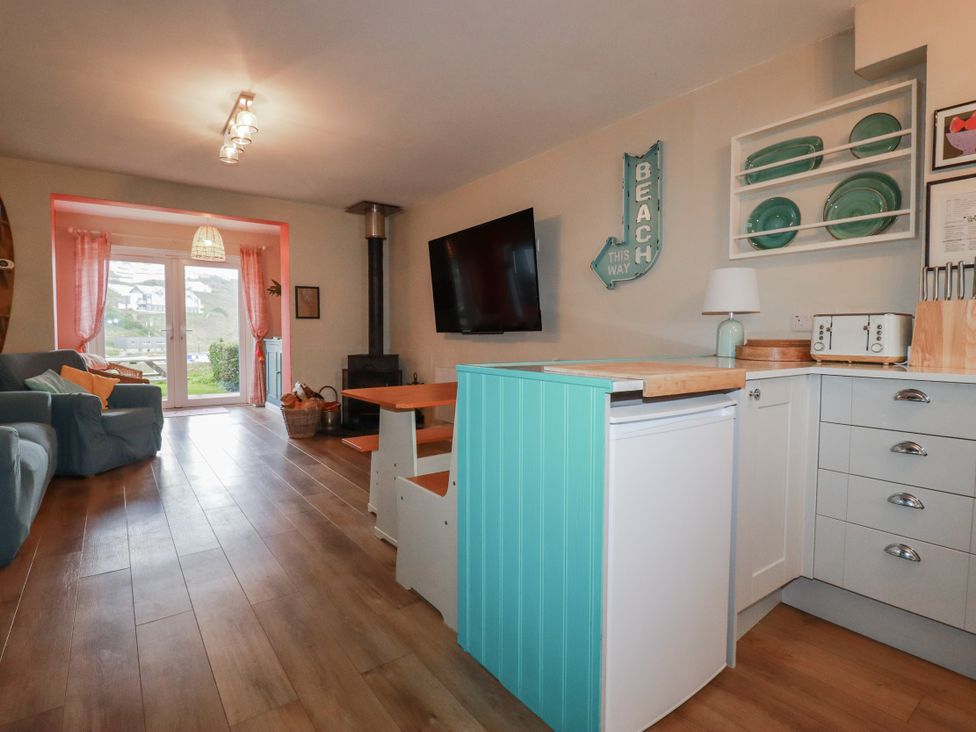 A living room with a sofa and television at Kippy Cottage in Porthtowan