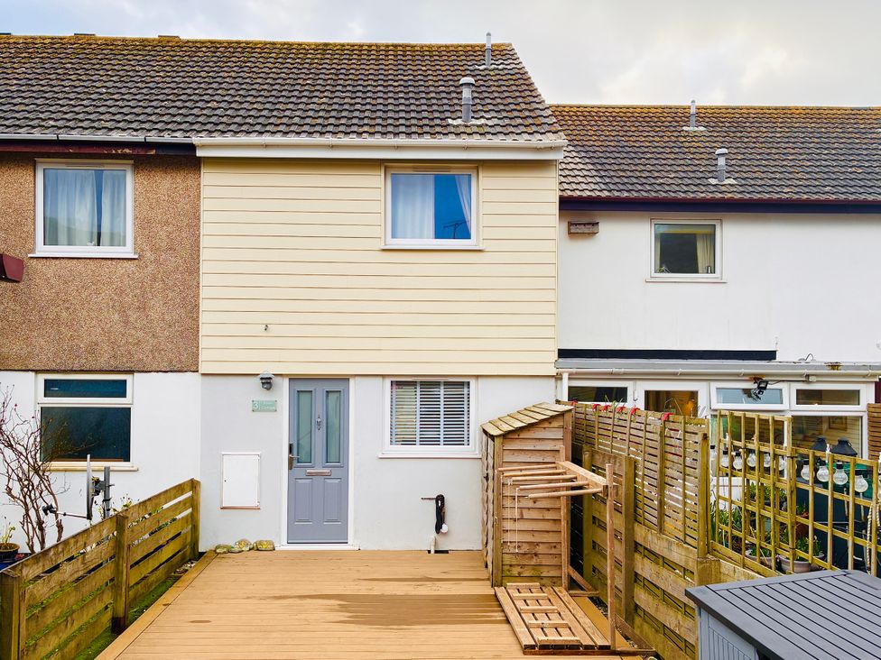 A house facade with a door and windows at Kippy Cottage in Porthtowan