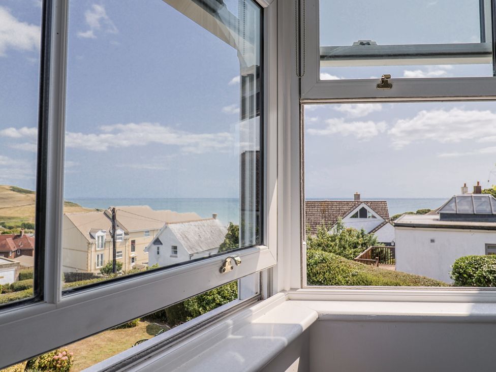 A view from a window showing the sea and houses at St Helena Charmouth