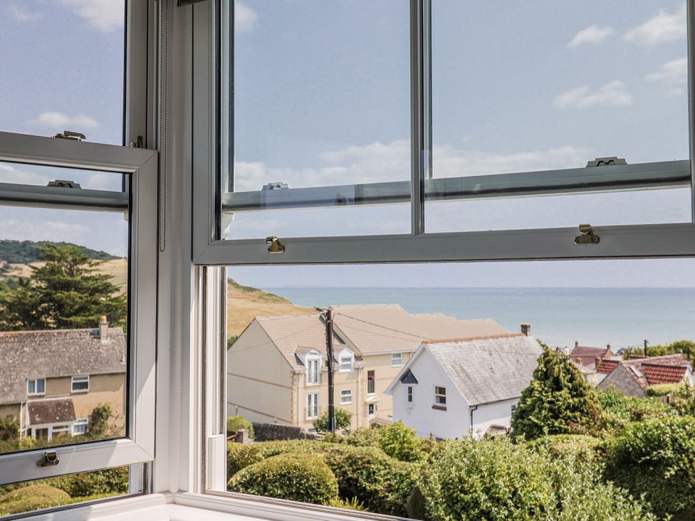 A view of the sea and houses from a window at St Helena in Charmouth