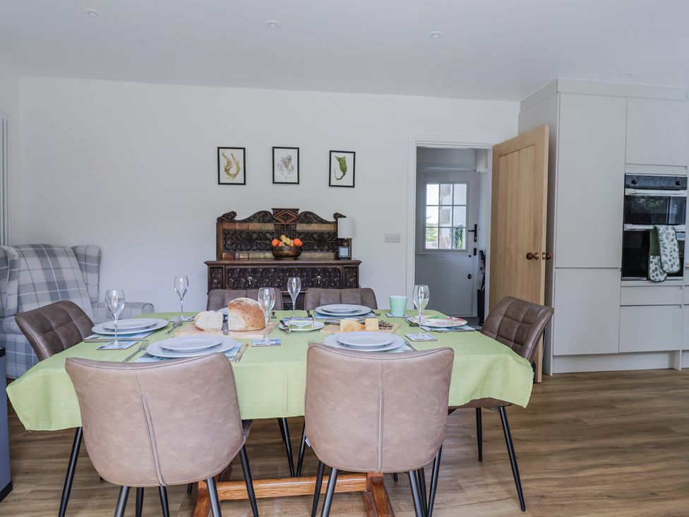 A dining room with a table set and a fruit bowl at St Helena Charmouth
