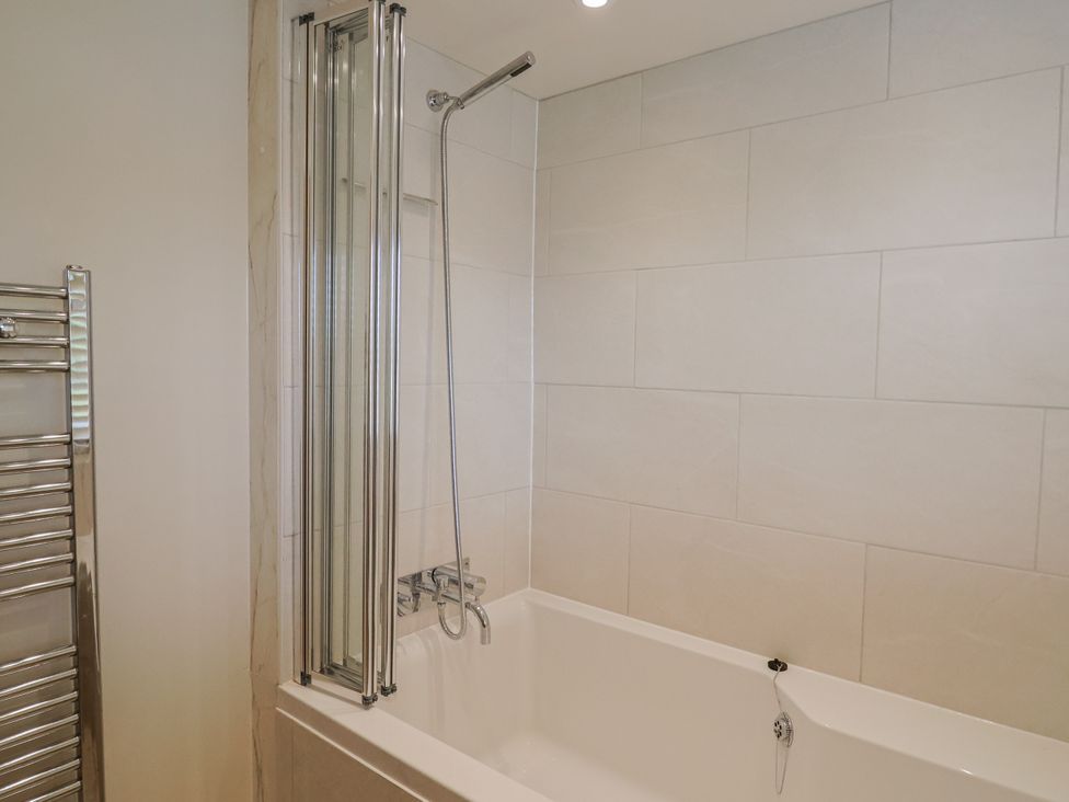 A bathroom with a bathtub and shower at St Helena in Charmouth